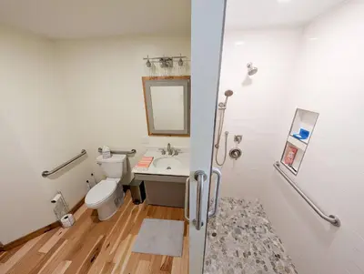 a bathroom with a white toilet and a sink at Fully Loaded Riverfront West Branch Fishing Cabin in Deposit