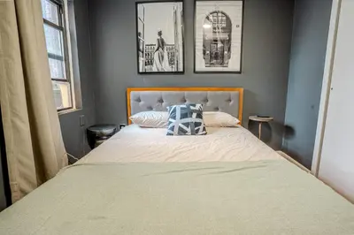 a bedroom with a bed with a pillow on it at Stylish 3BD Near Empire in New York