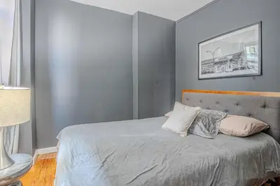 a bedroom with a bed with two pillows on it at Stylish 3BD Near Empire in New York