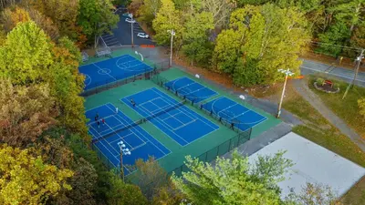 an overhead view of four tennis courts in a park at Access to Private Lake Pools Sports Complex • Fire Pit Foxden by AvantStay in East Stroudsburg