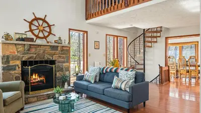 a living room with a couch and a fireplace at Pirate-Themed Lakefront Home w Kayaks Game Room Views Hidden Treasure Hunt in East Stroudsburg