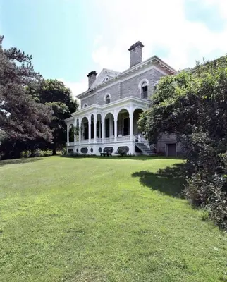 a large white house with a large grass field at The Stone House in Sharon Springs