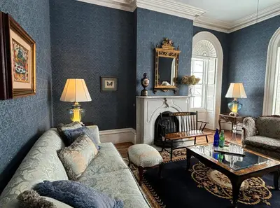 a living room with a couch and a table at The Stone House in Sharon Springs