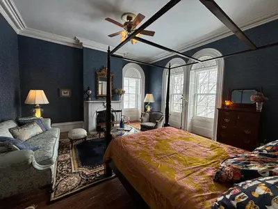 a bedroom with a bed and a ceiling fan at The Stone House in Sharon Springs