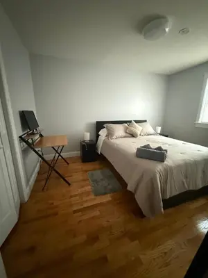 a bedroom with a bed and a desk in it at MetLife 10 Min 8 Guests Free Parking in Jersey City