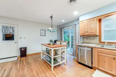 a kitchen with wooden cabinets and a counter top at Less Than 1 Mi to Main St Rural Gem in Cherry Valley in Cherry Valley