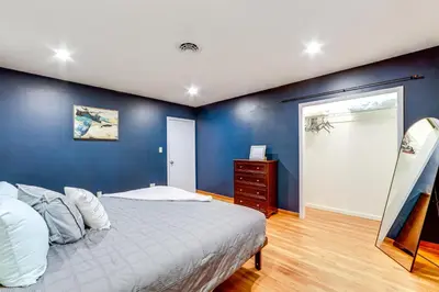 a bedroom with a bed and a blue wall at Less Than 1 Mi to Main St Rural Gem in Cherry Valley in Cherry Valley