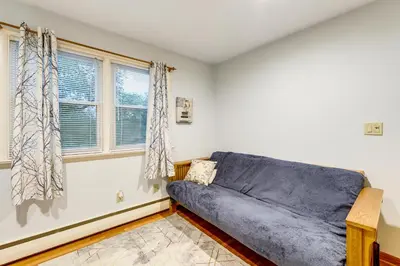 a living room with a blue couch and a window at Less Than 1 Mi to Main St Rural Gem in Cherry Valley in Cherry Valley