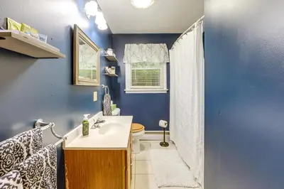 a blue bathroom with a sink and a toilet at Less Than 1 Mi to Main St Rural Gem in Cherry Valley in Cherry Valley