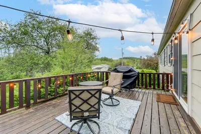 a balcony with a table and chairs on a wooden deck at Less Than 1 Mi to Main St Rural Gem in Cherry Valley in Cherry Valley