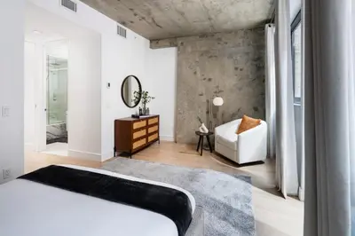 a bedroom with a bed and a mirror and a chair at Stunning Apartment in Manhattan with Patio in New York