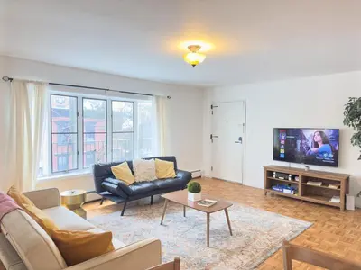 a living room with a couch and a tv at Huge Place Minutes from NYC Parking Available in Guttenberg