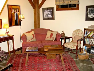 a living room with a couch and a coffee table at Owl's Nest Lodging