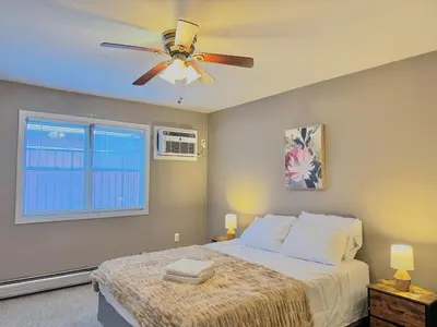 a bedroom with a bed and a ceiling fan at Spacious and Convinient near NYC Parking Available in Guttenberg