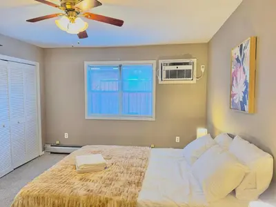 a bedroom with a bed and a ceiling fan at Spacious and Convinient near NYC Parking Available in Guttenberg
