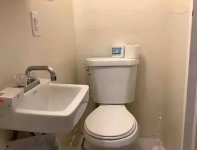 a bathroom with a white toilet and a sink at sarah suite in Mount Vernon