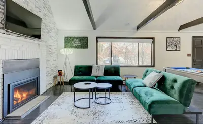 a living room with a couch and a fireplace at Modern 4 Bedroom Home with Sauna and Game Room in Gated Lake Community in East Stroudsburg