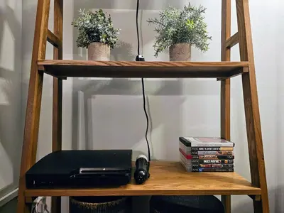 a book shelf with plants and a printer on it at Massive 5BD/4BA 3-Story Duplex @ Downtown Albany in Albany