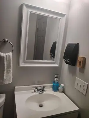 a bathroom with a white sink and a mirror at Massive 5BD/4BA 3-Story Duplex @ Downtown Albany in Albany
