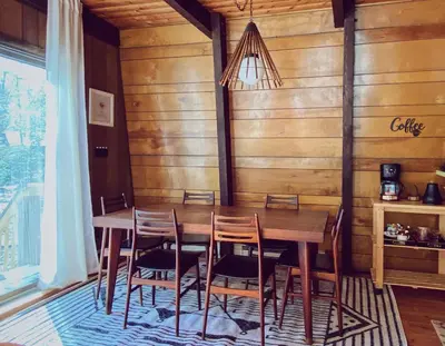 a dining room with a wooden table and chairs at Designer Poconos Chalet I Ski, Skate, Lakes, Family-Friendly in Lake Ariel