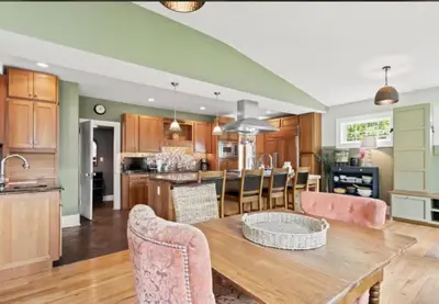 a kitchen and living room with a wooden table and chairs at Majestic Family Home in Saratoga New York in Saratoga Springs