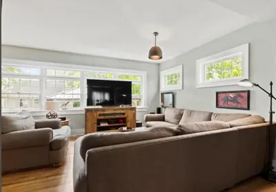 a living room with a couch and a tv at Majestic Family Home in Saratoga New York in Saratoga Springs