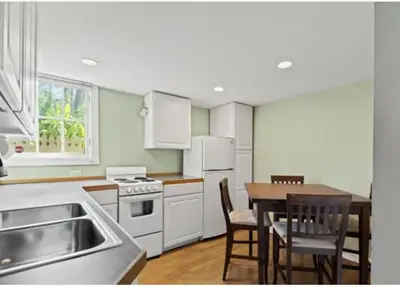 a kitchen with white appliances and a table and chairs at Majestic Family Home in Saratoga New York in Saratoga Springs