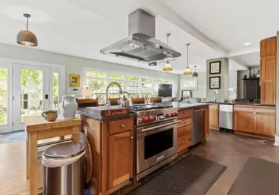 a large kitchen with wooden cabinets and stainless steel appliances at Majestic Family Home in Saratoga New York in Saratoga Springs