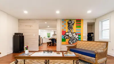 a living room with a couch and a table at Pondfront Gem Minutes from Hudson’s Best Shops Cafes The Stillwater House in Hudson