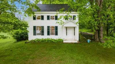 a white house with a tree and a yard at Pondfront Gem Minutes from Hudson’s Best Shops Cafes The Stillwater House in Hudson