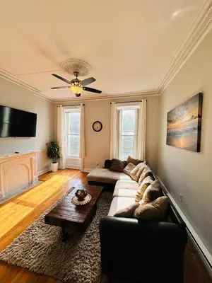 a living room with a couch and a table at Charming, Spacious Apartment Downtown Albany in Albany