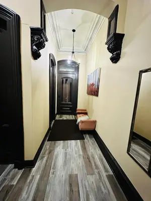 a hallway with a door and a couch at Charming, Spacious Apartment Downtown Albany in Albany