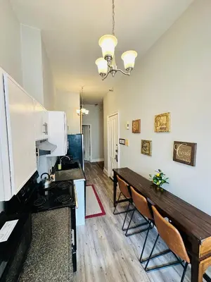 a kitchen with a table and chairs in a room at Charming, Spacious Apartment Downtown Albany in Albany
