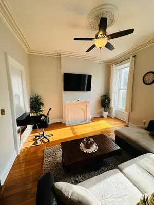 a living room with a couch and a piano at Charming, Spacious Apartment Downtown Albany in Albany