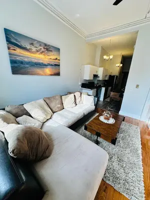 a living room with a couch and a coffee table at Charming, Spacious Apartment Downtown Albany in Albany