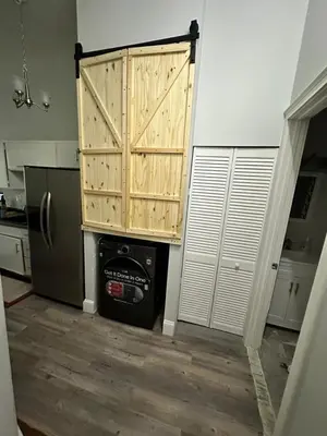 a kitchen with a refrigerator and a wooden door at Charming, Spacious Apartment Downtown Albany in Albany