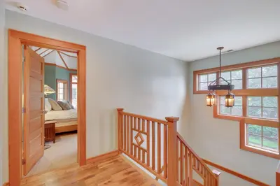 a hallway with a staircase leading to a bedroom at Luxe Family Home on Orange Lake with Private Dock! in Newburgh