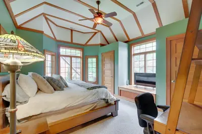 a bedroom with a bed and a ceiling fan at Luxe Family Home on Orange Lake with Private Dock! in Newburgh