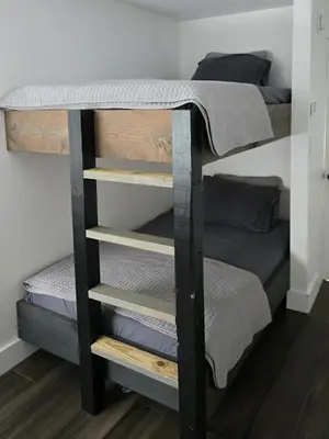 a bunk bed in a room with four bunk beds at House 15 mins from Woodstock NY with stunning views in Shokan