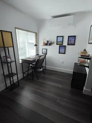 a living room with a desk and a table at House 15 mins from Woodstock NY with stunning views in Shokan