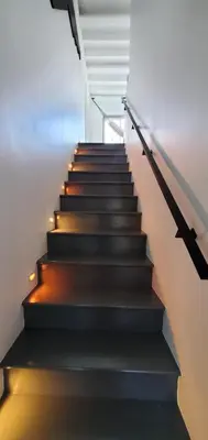 a staircase with black steps with lights on it at House 15 mins from Woodstock NY with stunning views in Shokan