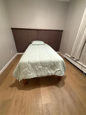 a bedroom with a bed and a wooden floor at 15 mins to NYC-Great Apartment Great for Family in West New York