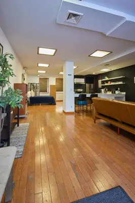 an empty lobby with a couch and a table at The Luxe Loft in Long Island City
