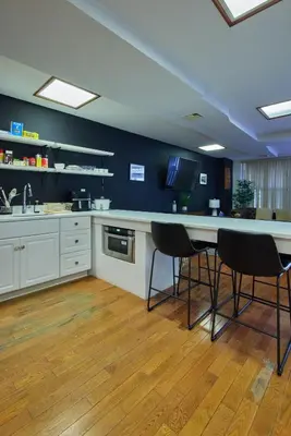 a kitchen with a table and chairs in it at The Luxe Loft in Long Island City
