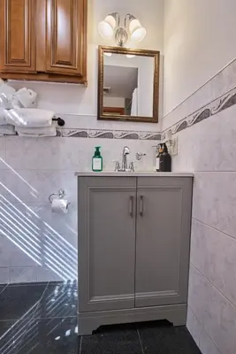 a bathroom with a sink and a mirror at The Luxe Loft in Long Island City