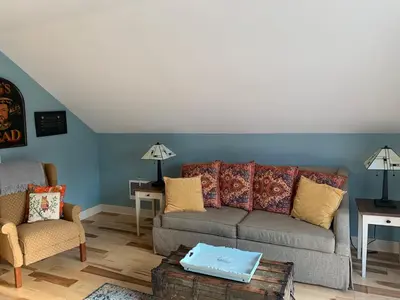 a living room with a couch and a chair at Apartment on the Battenkill River in Greenwich