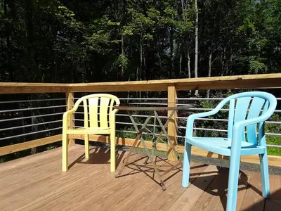 two chairs and a table on a deck at Apartment on the Battenkill River in Greenwich