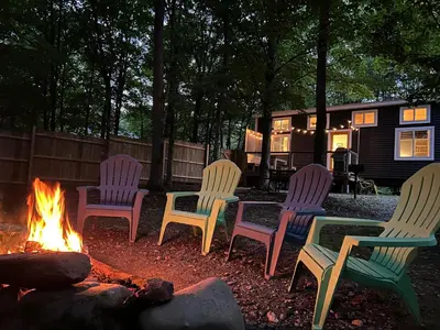 a group of chairs sitting around a fire in a yard at Tiny House on the Battenkill River in Greenwich