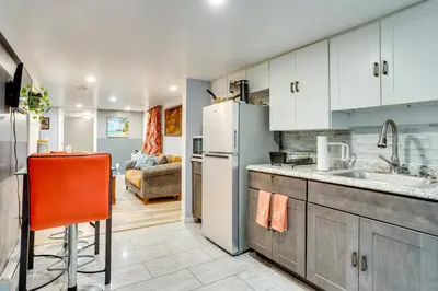 a kitchen with a sink and a refrigerator at Apt 2 Mi to Prudential Center and Dtwn Newark! in Newark