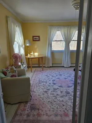 a living room with a couch and a table at Captain Tiffany's in Saugerties
